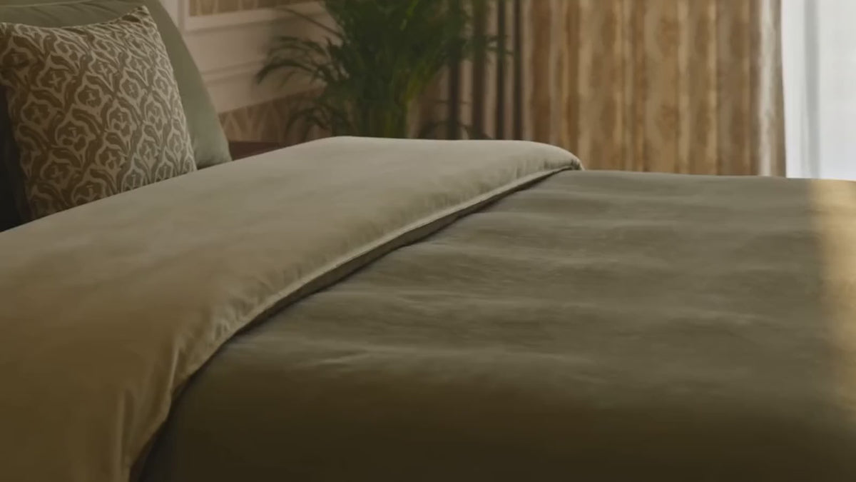 Load video: A luxury bedroom dressed in Jagdish Store linen, soft morning light through patterned curtains