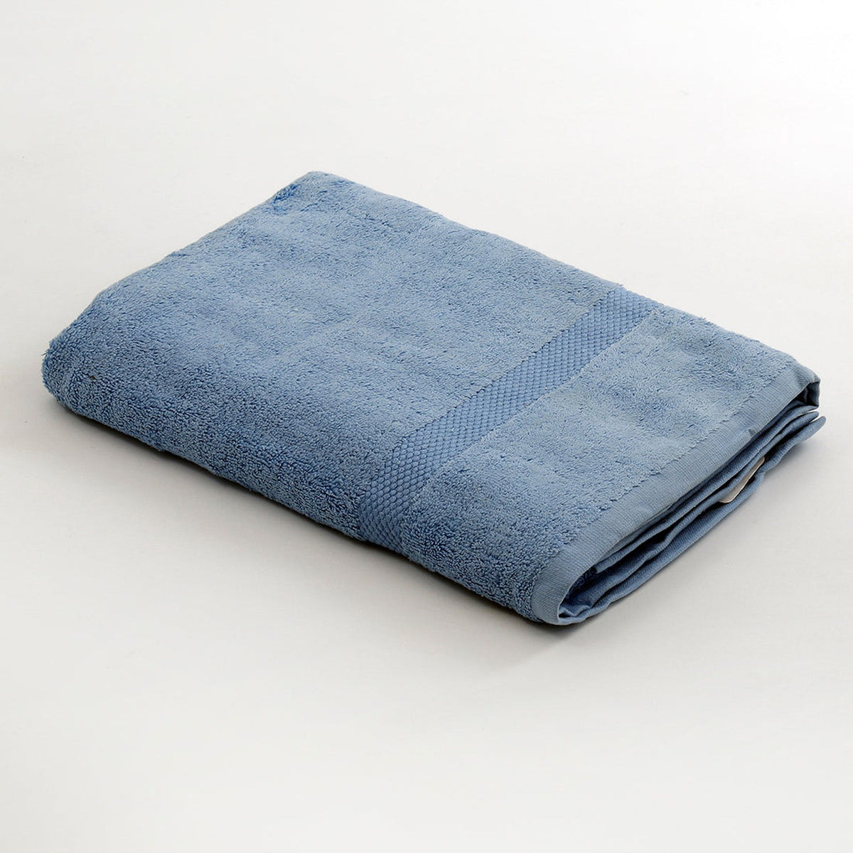 Light blue cotton bath towel folded diagonally with a honeycomb woven border