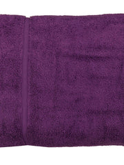 Deep purple cotton bath towel, close-up rolled view showing the woven dobby border