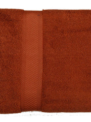 Rust brown cotton bath towel with a tonal woven border, folded, 30x60 inch