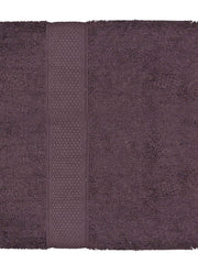 Deep plum-purple cotton bath towel, close-up flat view showing the honeycomb woven border