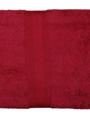 Deep maroon-red cotton bath towel, close-up rolled view showing the woven dobby border
