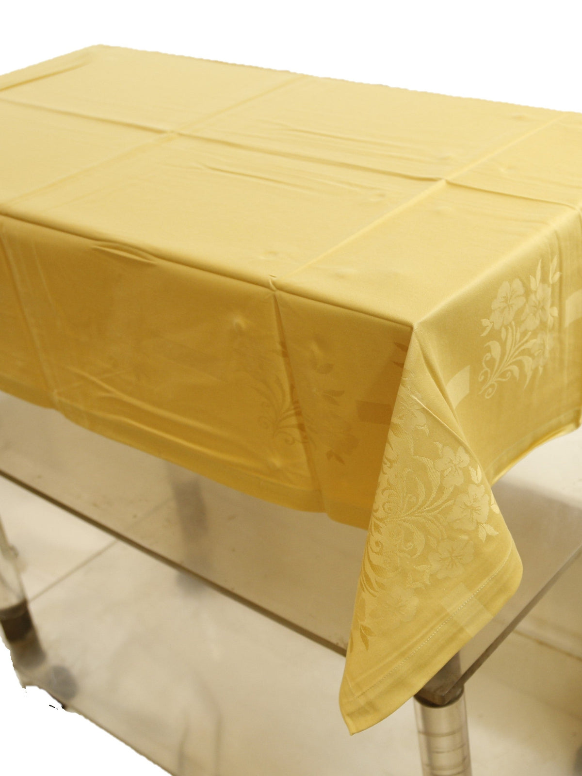 Pale gold self-jacquard table cover with a tone-on-tone floral damask pattern