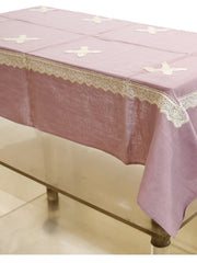 Solid lavender linen table cover with small white embroidered cross motifs and a white crochet lace border