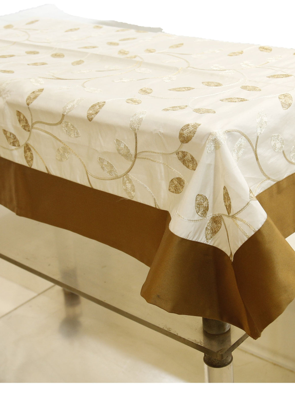 Cream table cover with a gold embroidered leaf-and-vine pattern and a solid brown border