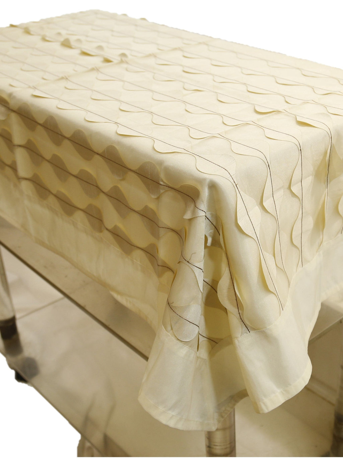 Cream table cover with a wavy ripple-appliqué stripe pattern and a scalloped hem