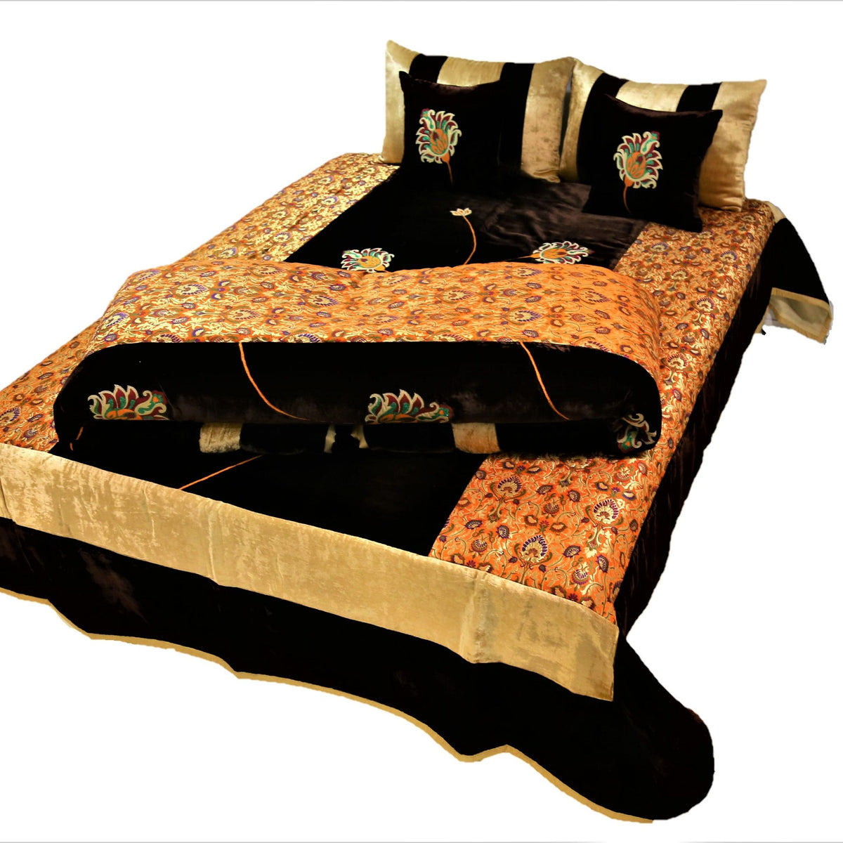 Black and gold flower embroidered velvet wedding set on a double bed, angled view