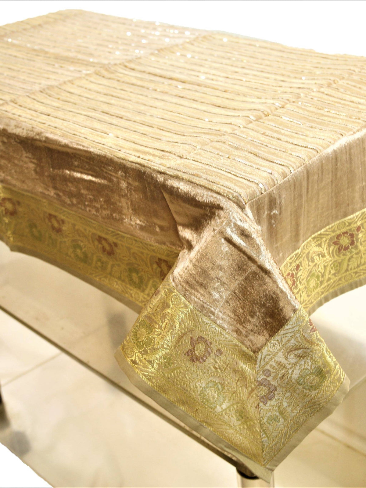 Champagne-beige velvet table cover with a sequinned stripe pattern and a gold brocade floral border