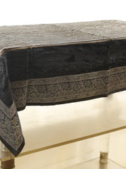 Black velvet table cover with a silver sequinned stripe pattern and a grey-gold floral brocade border