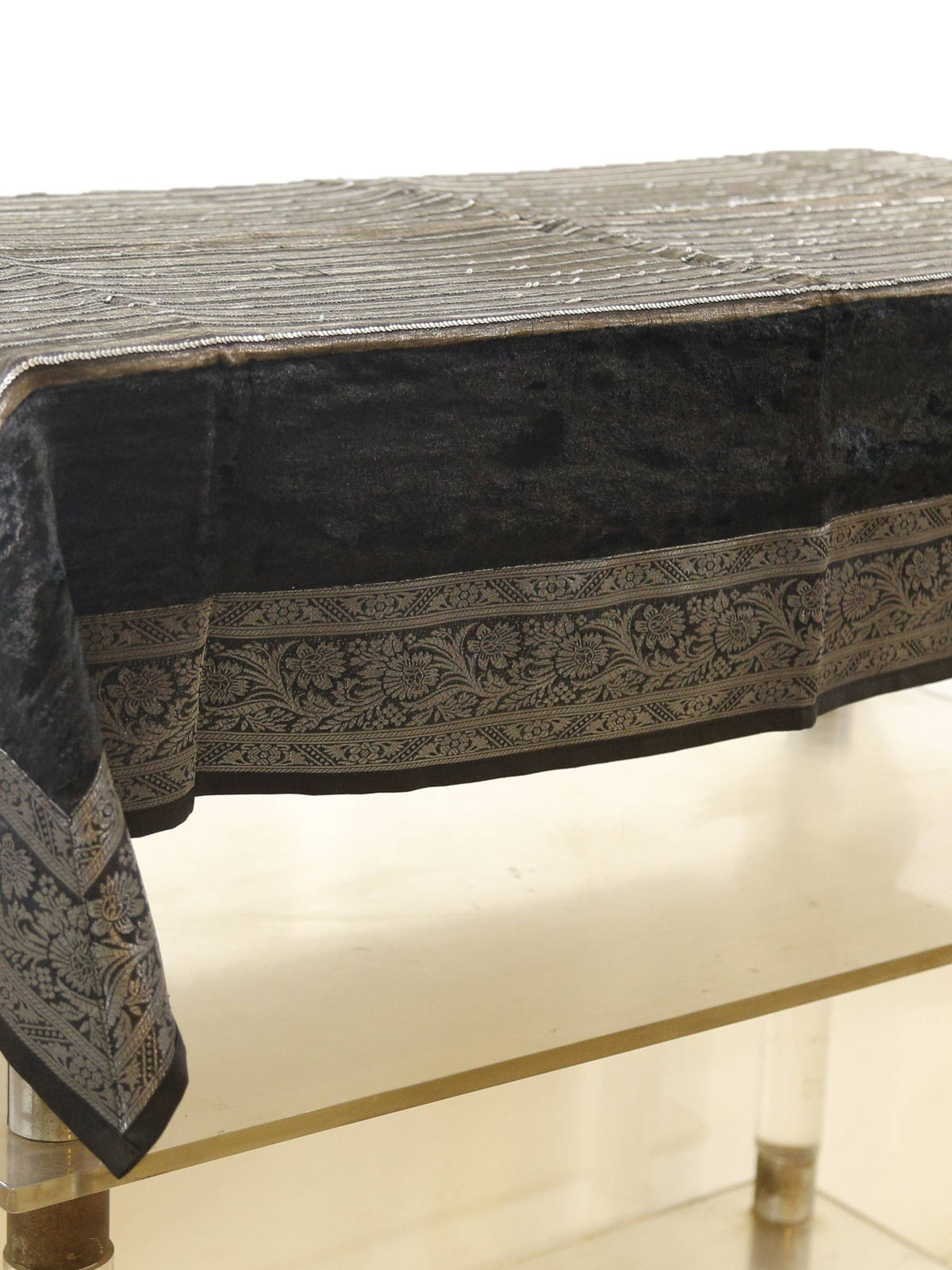 Black velvet table cover with a silver sequinned stripe pattern and a grey-gold floral brocade border