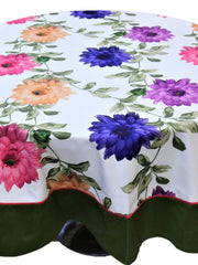 Round white table cover with a large multicolour floral print and a solid olive-green underskirt with red piping