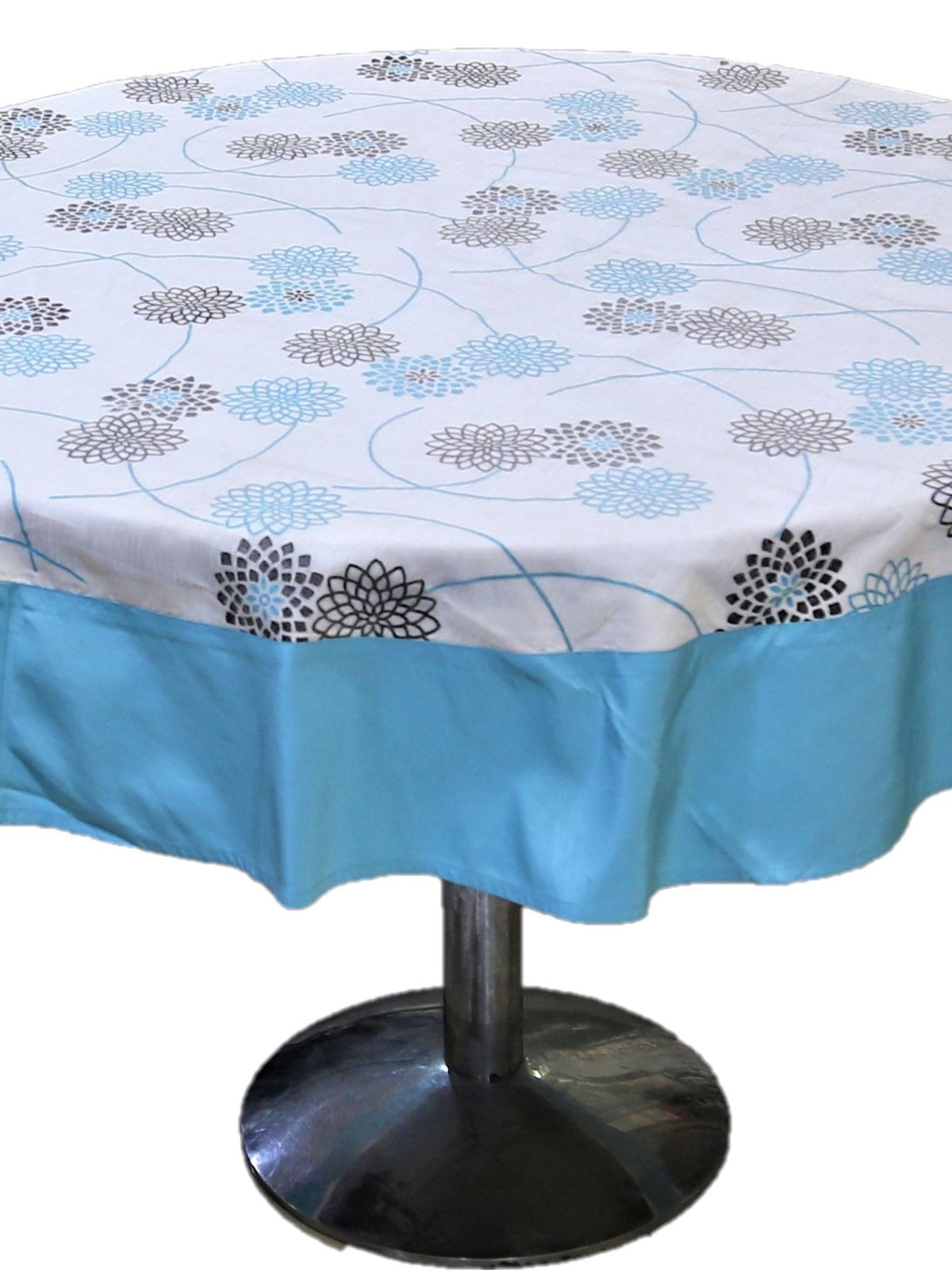 Round white table cover with a black and blue floral burst print and a solid sky-blue underskirt