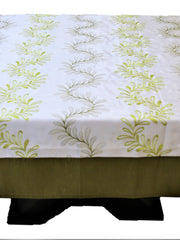 White table cover with a green embroidered fern-leaf pattern and a solid olive-green underskirt