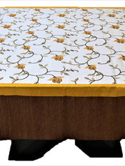 White table cover with a multicolour embroidered floral vine pattern, a gold trim, and a solid brown underskirt