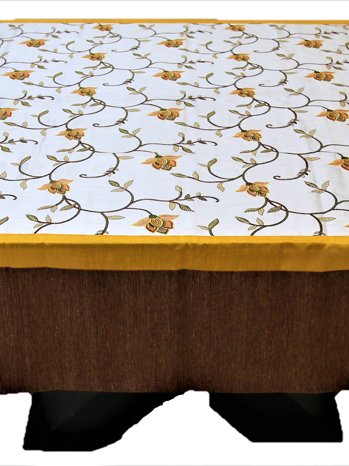 White table cover with a multicolour embroidered floral vine pattern, a gold trim, and a solid brown underskirt