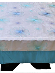 White table cover with a pale blue embroidered flower pattern and a solid teal-blue underskirt