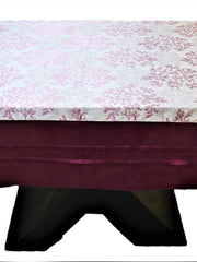 White table cover with a printed magenta tree-branch floral pattern and a solid maroon underskirt