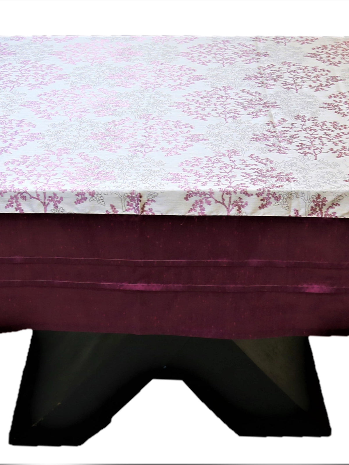 White table cover with a printed magenta tree-branch floral pattern and a solid maroon underskirt