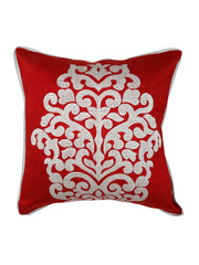 Red silk cushion cover with a large cream embroidered damask crest and white piping