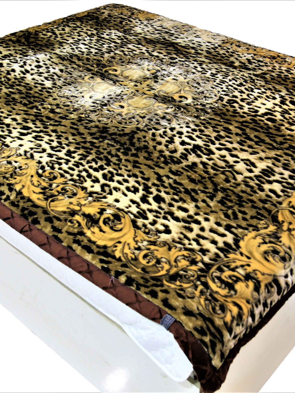 Gold-brown leopard-print blanket with a scroll medallion border