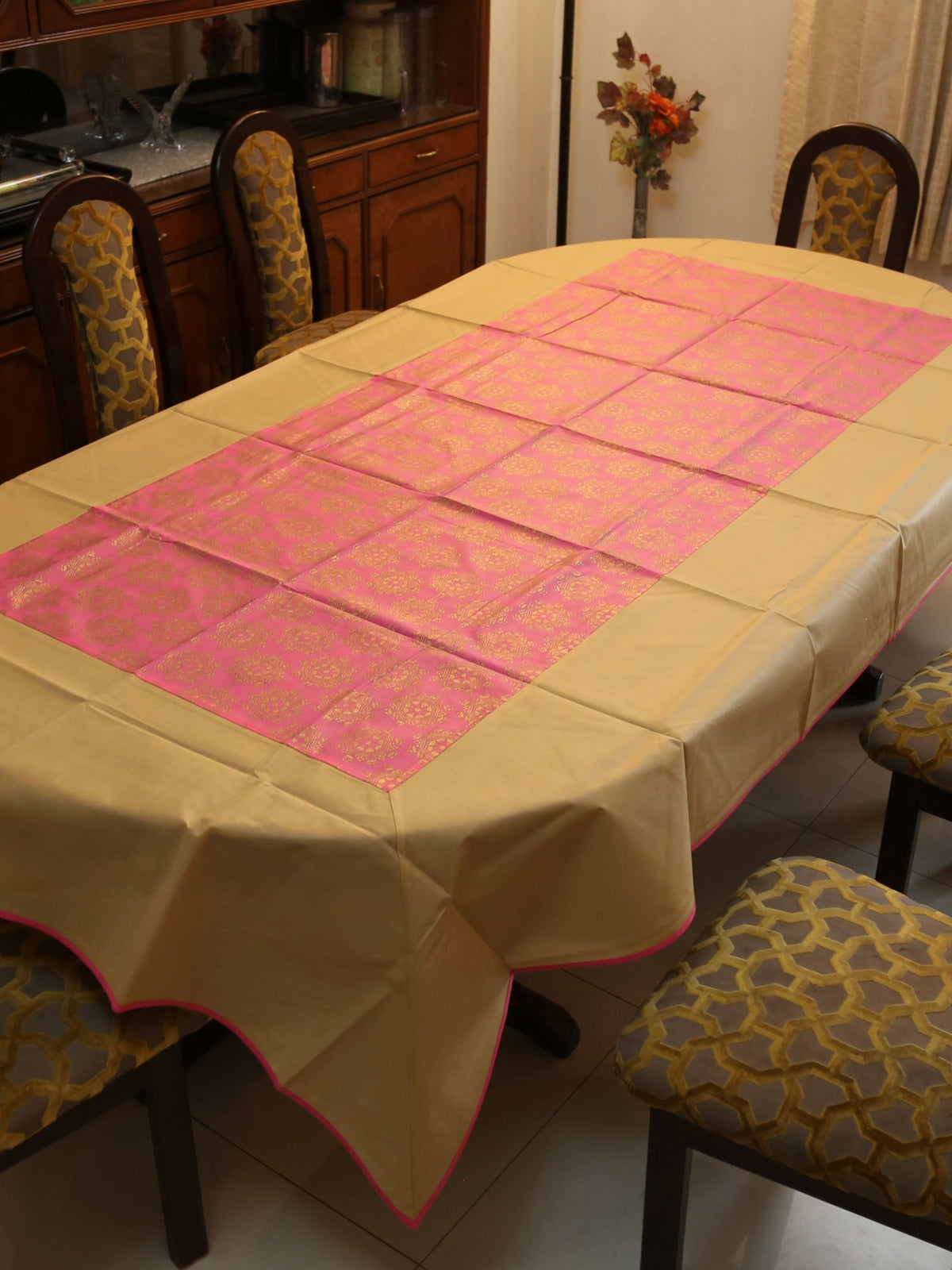 Gold-beige table cover with a contrasting pink brocade panel woven down the centre