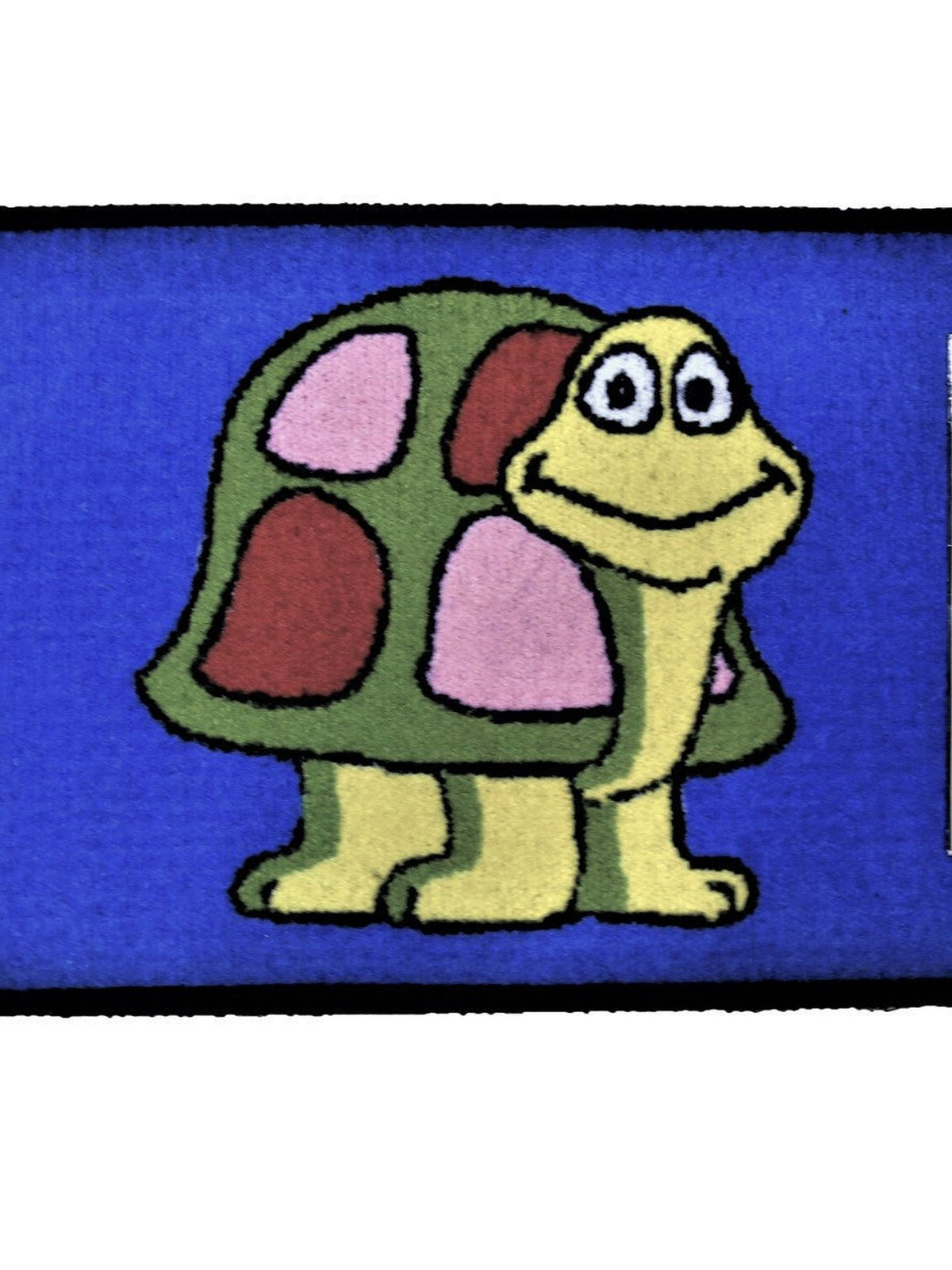 Blue kids play mat with a cartoon turtle with a green shell patterned in pink and maroon, 45x75 cm