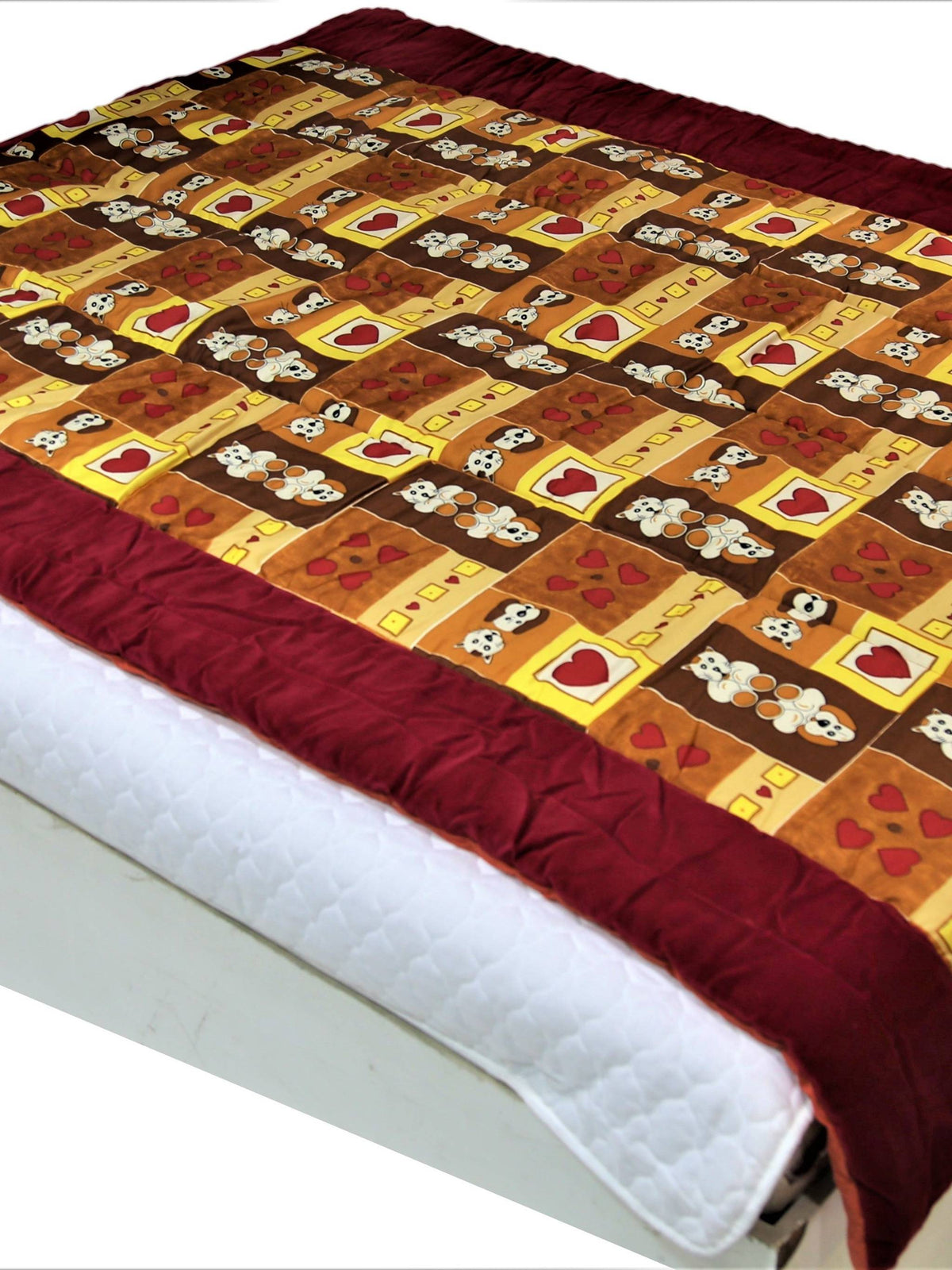 Brown and gold cotton single bed quilt with skull-and-heart novelty print and maroon border