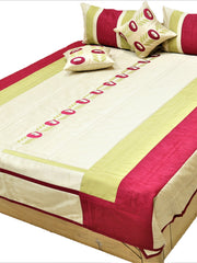 Cream and crimson striped quilted bedcover set made up on a double bed with bolsters