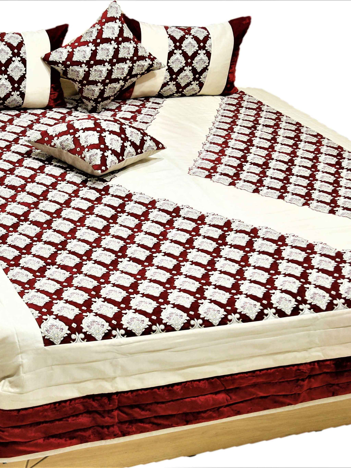 Maroon and cream traditional print quilted bedcover set made up on a double bed