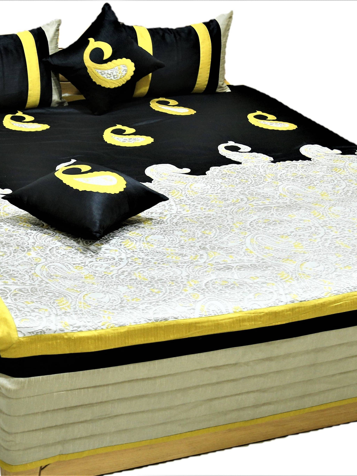 Black silk bedcover with yellow paisley applique and ivory brocade panel, matching cushions