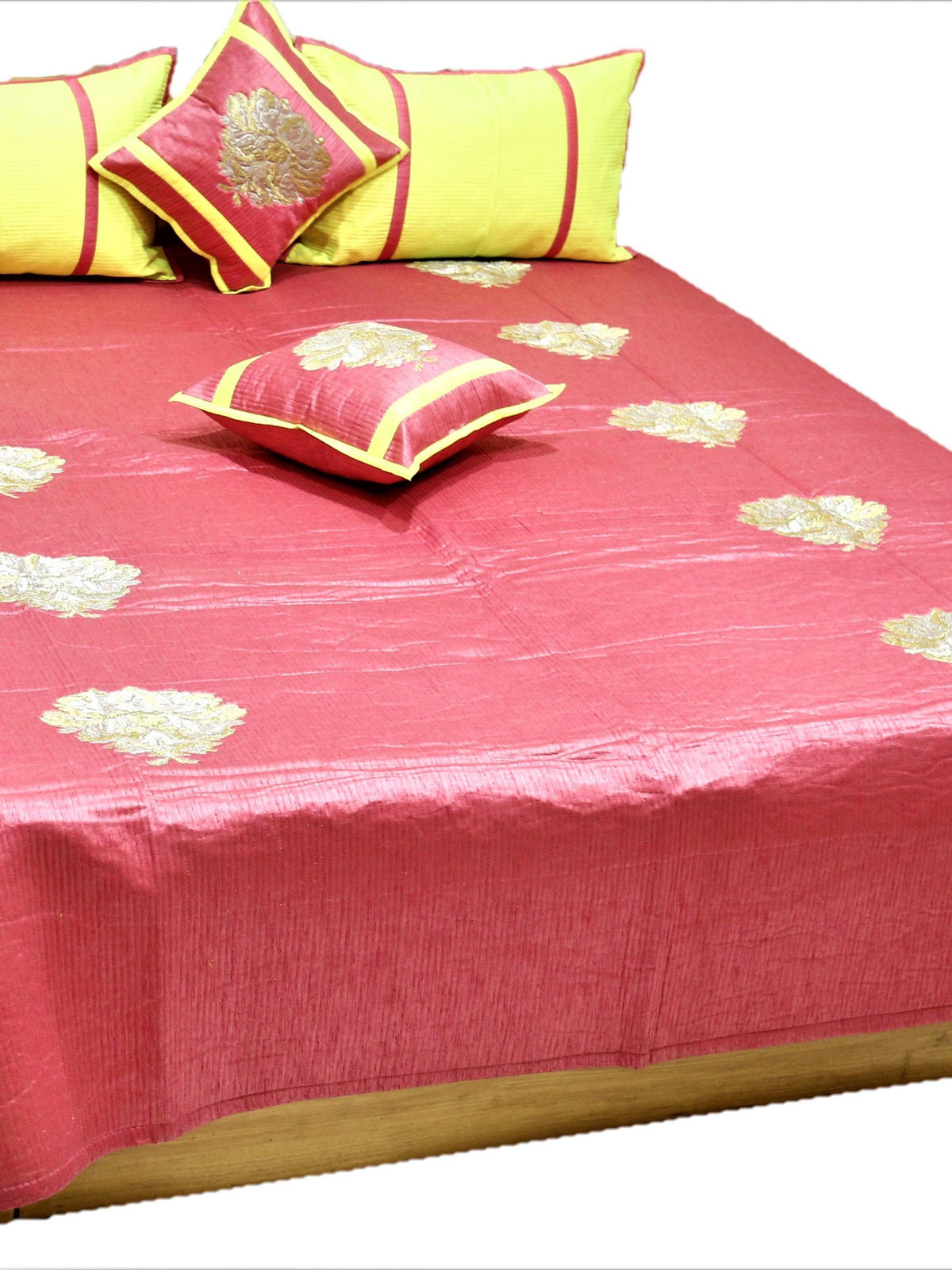 Coral rose silk bedcover with gold and silver zari floral motifs and lemon bolster covers