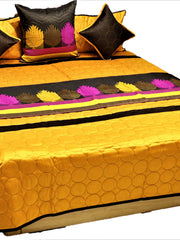 Marigold gold bedcover with circle quilting and lotus applique band, brown and pink cushions