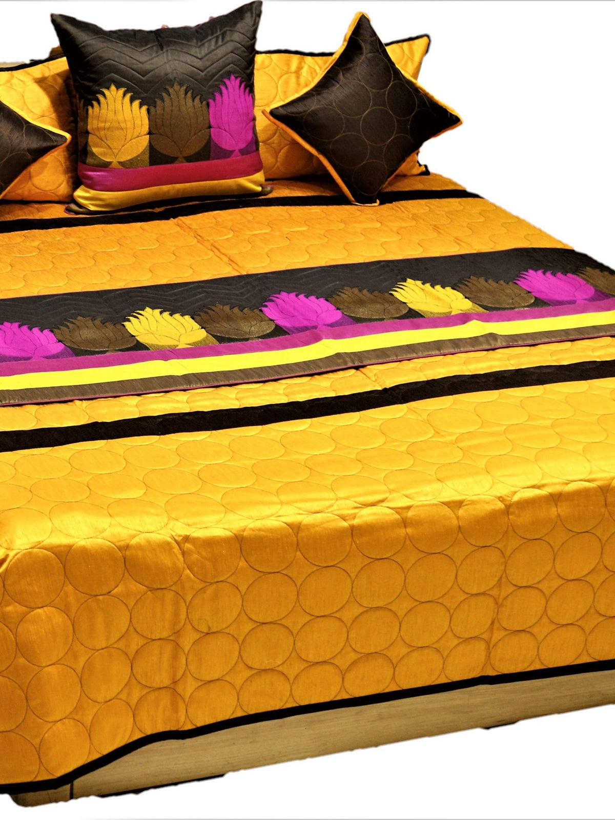 Marigold gold bedcover with circle quilting and lotus applique band, brown and pink cushions