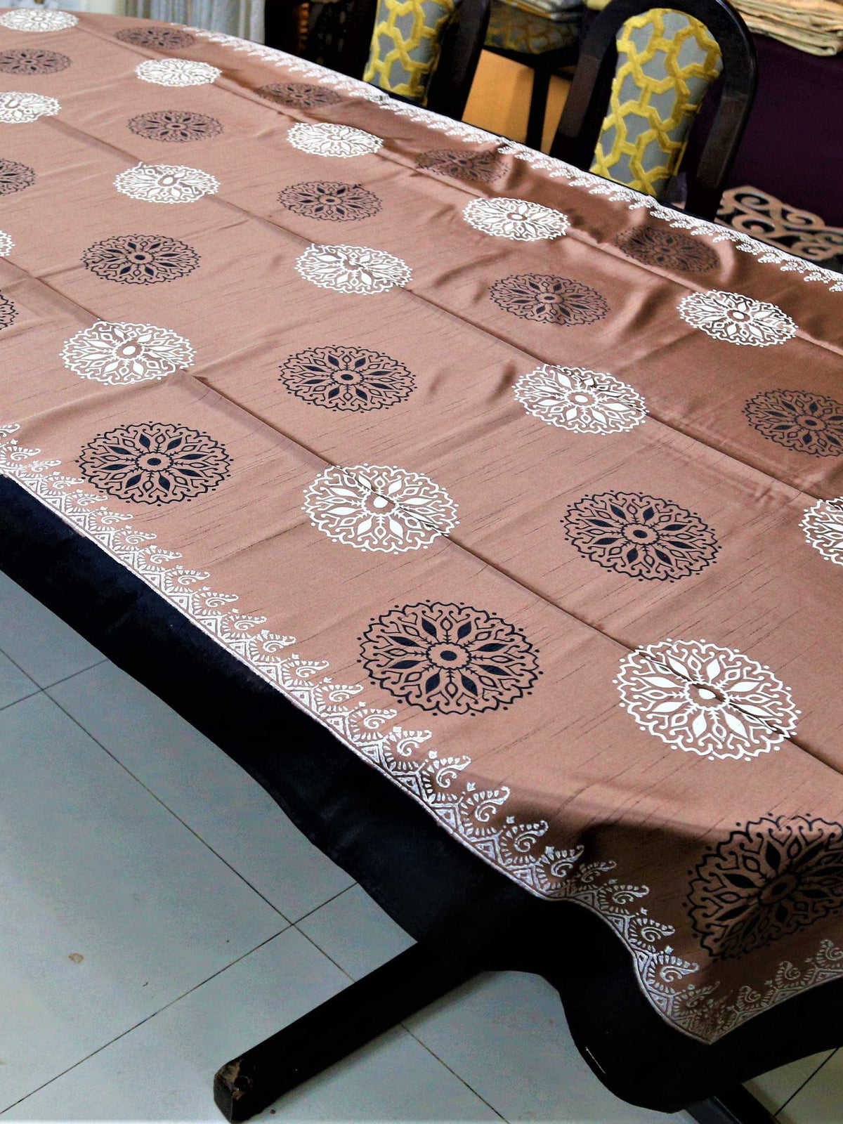 Dusty pink-brown table cover with a black and white block-printed mandala medallion pattern and a black lace-trimmed border