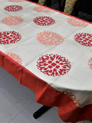 Cream table cover with a cutwork circular floral medallion pattern and a solid gajri-red border