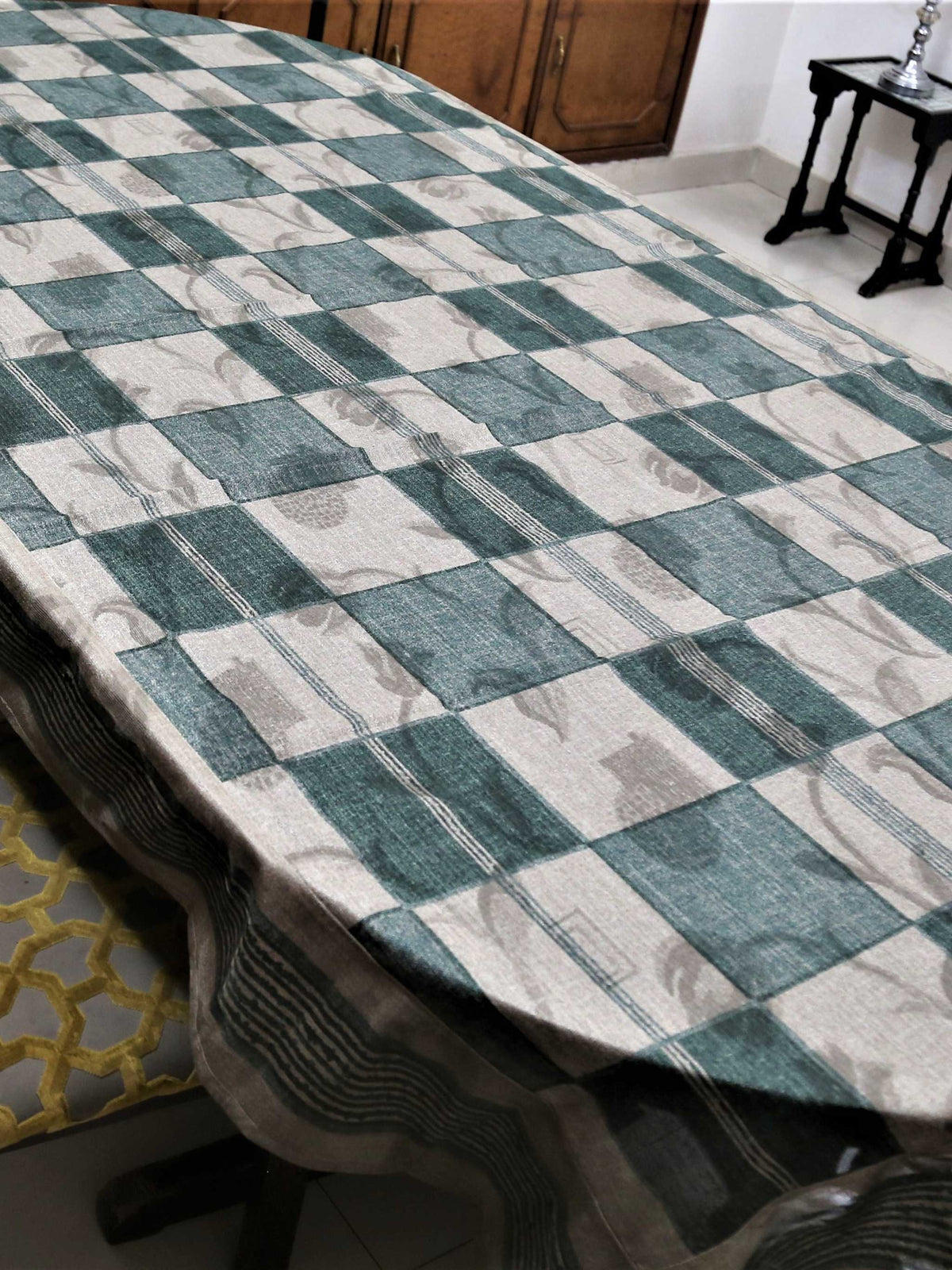Green and cream checkered table cover with a self-tone floral jacquard pattern and a sheer green underskirt