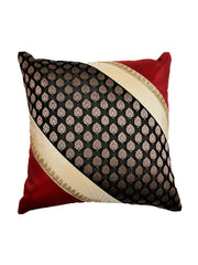 Red silk cushion cover with a diagonal black and gold brocade band and zari trim