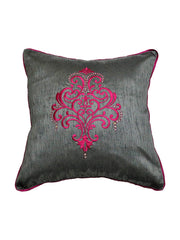 Charcoal-grey cushion cover with a magenta-pink embroidered scroll medallion and crystal beading, magenta piping