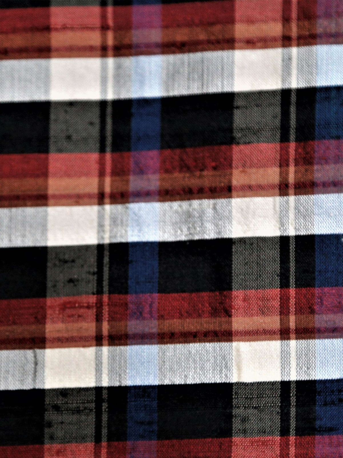 Dupion silk check fabric in rust, cream, black, and navy windowpane stripes