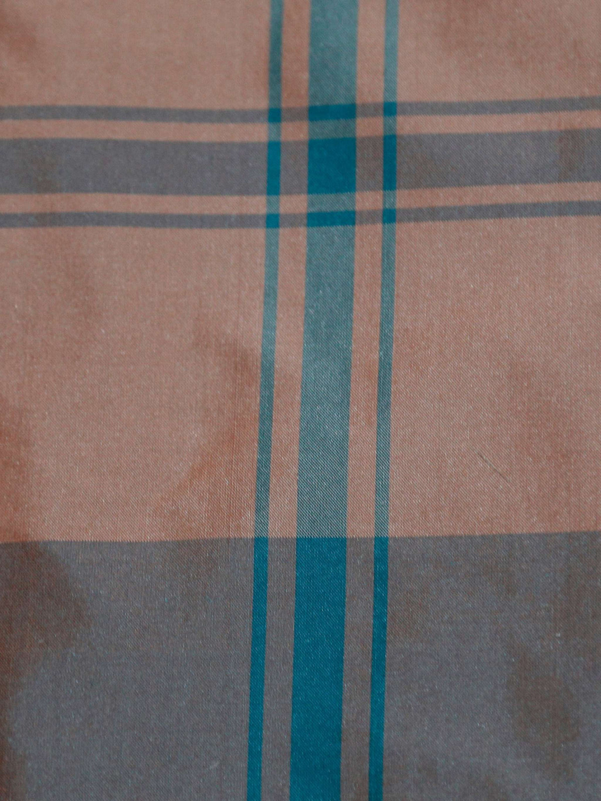 Cinnipatta silk upholstery fabric in a dusty peach and slate blue check with teal stripe lines