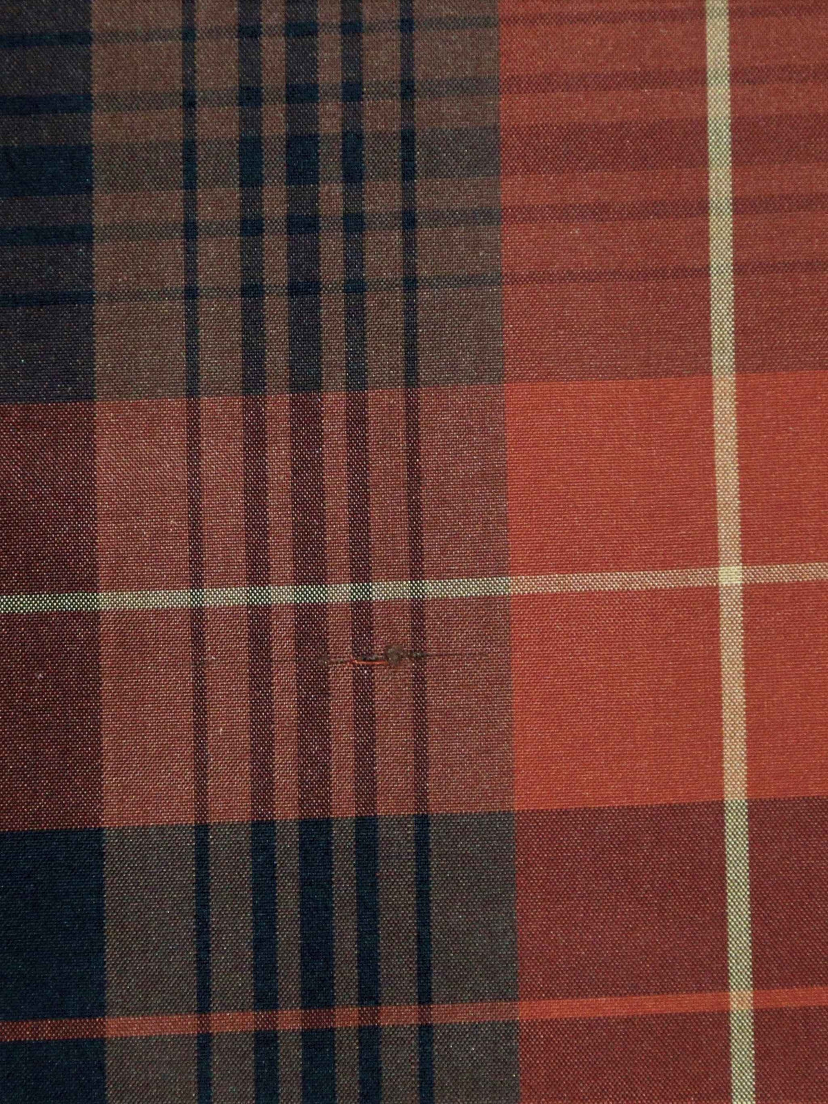 Rust-orange and black polysilk upholstery fabric in a windowpane check