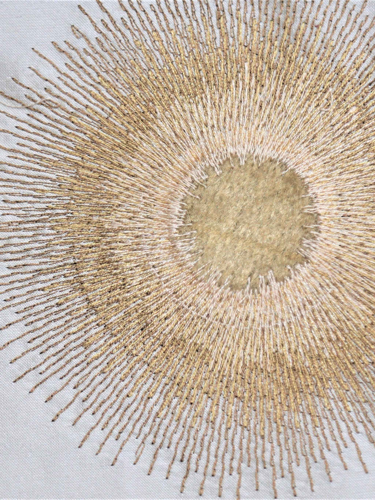 Ivory silk upholstery fabric with a rich gold embroidered sunburst motif