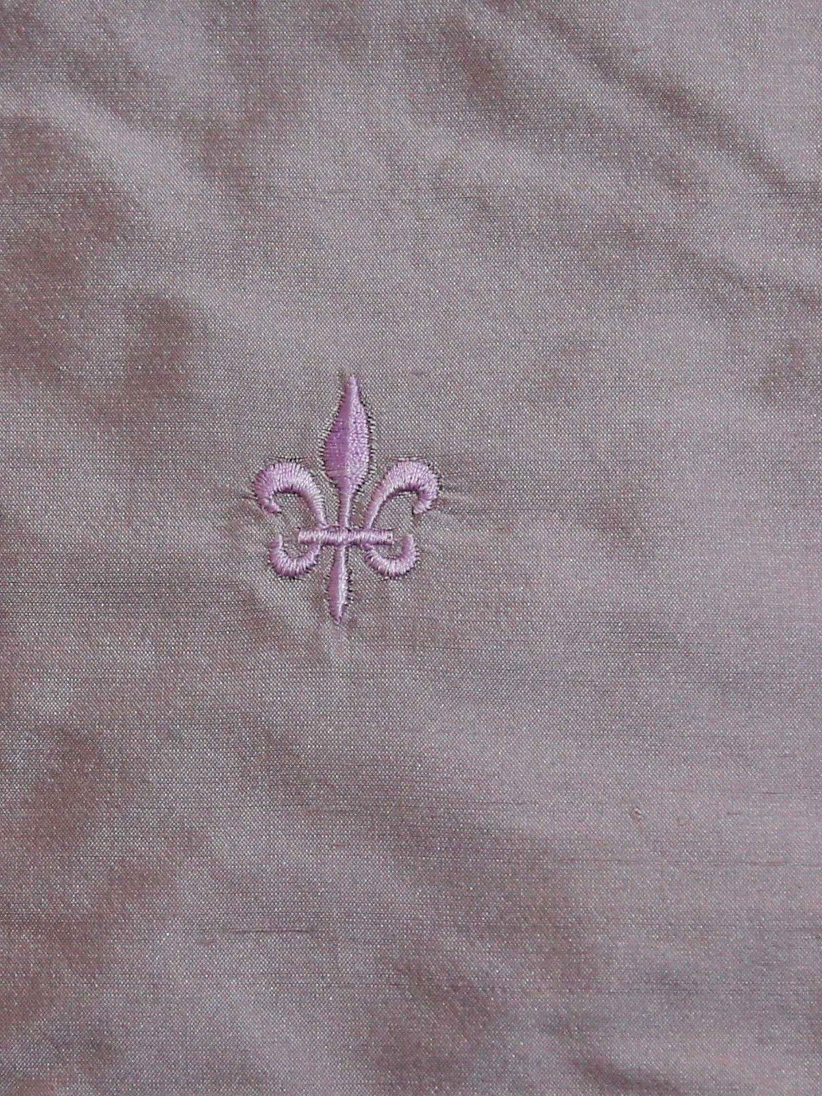 Mauve silk upholstery fabric with a tone-on-tone embroidered fleur-de-lis motif