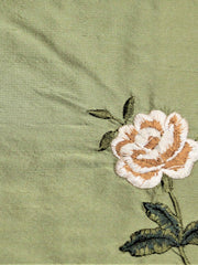 Sage-green silk upholstery fabric with an embroidered rose motif in cream and tan