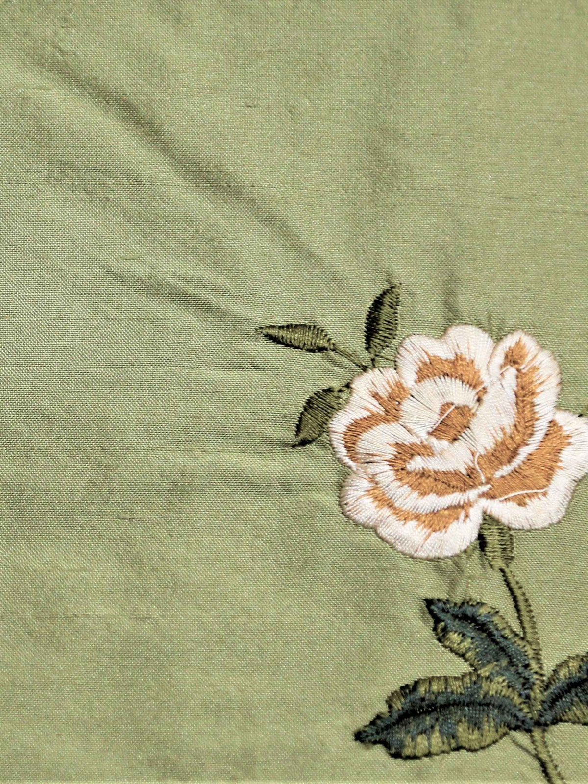 Sage-green silk upholstery fabric with an embroidered rose motif in cream and tan
