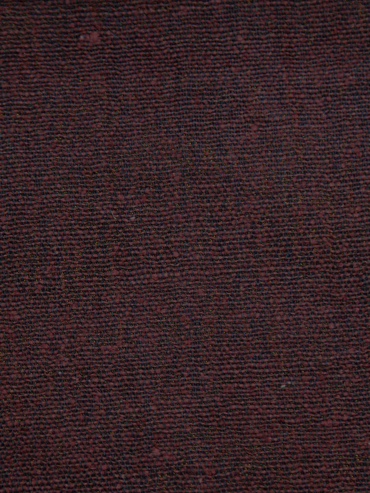 Maroon jute upholstery fabric with a firm, textured weave