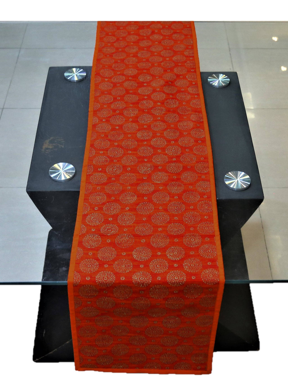 Rust orange dupion silk table runner with a block-printed circle motif