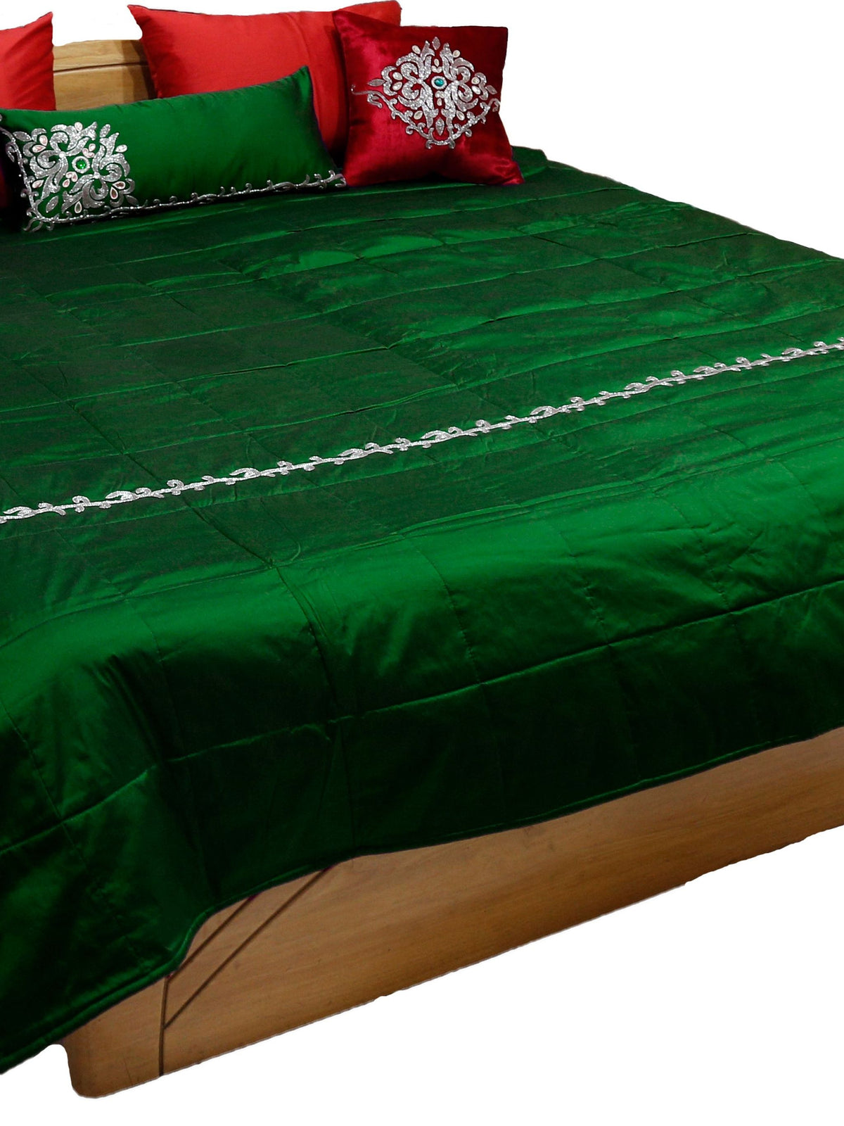 Bottle green silk bedcover with silver pearl work vine band and red embroidered cushions
