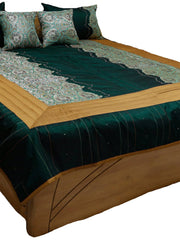 Deep teal silk bedcover with turquoise paisley brocade panels and gold quilted border