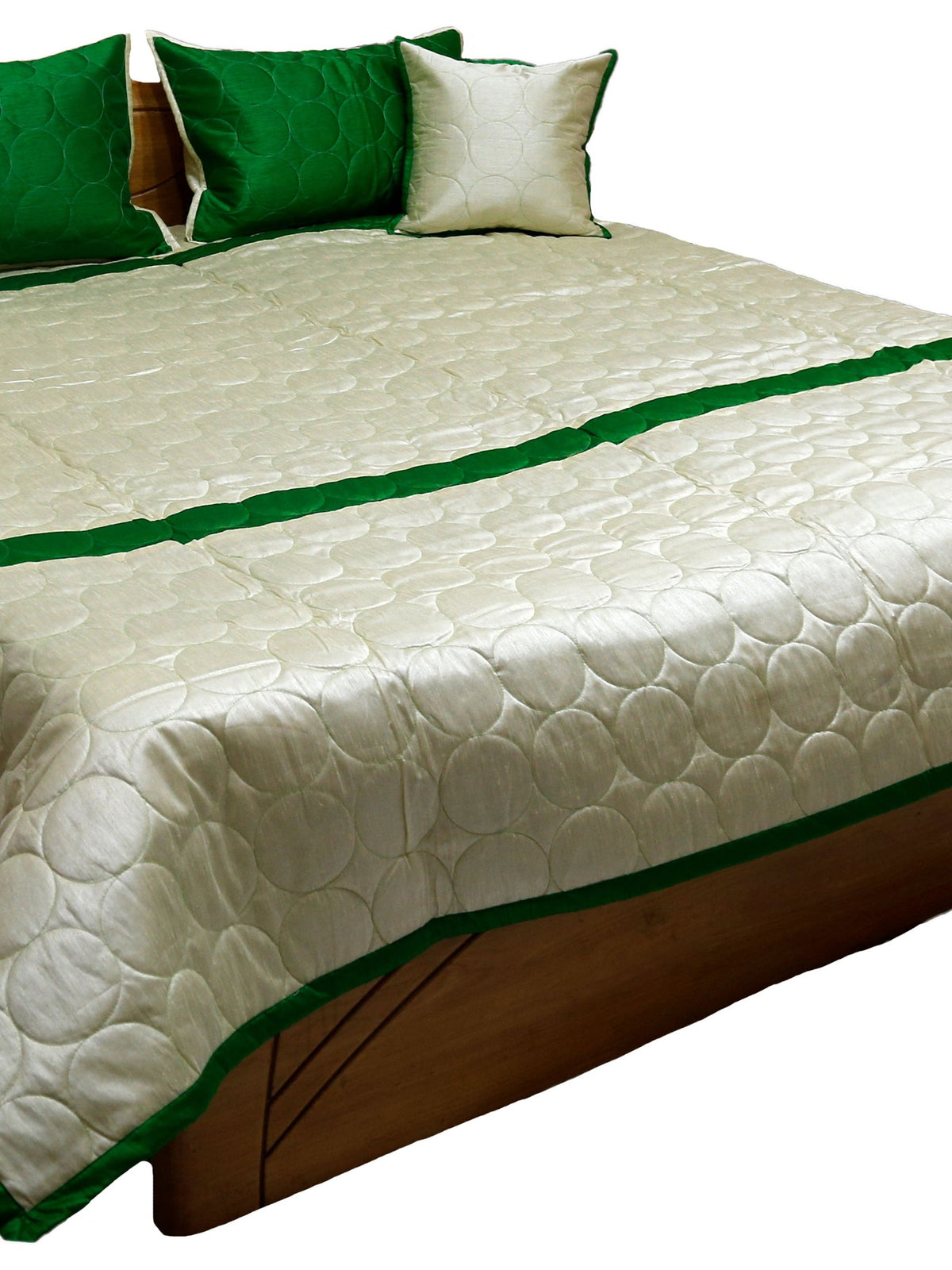 Ivory silk bedcover with circle quilting and green border, green and ivory cushion covers